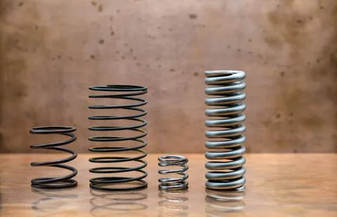 Different sizes of springs. Copper background. Stock Photos