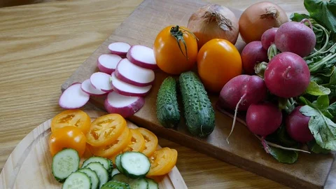 Different sliced vegetables, cucumber, radish, tomatoes and onions. Stock Footage 90624534