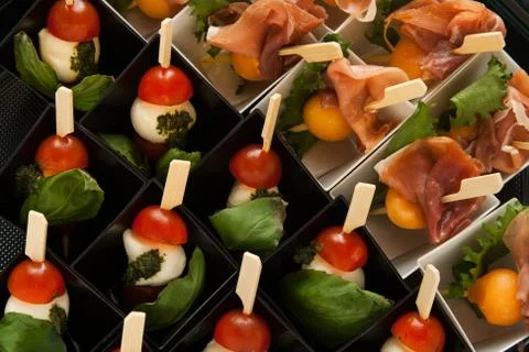 Different snack on skewer in mini box Stock Photos