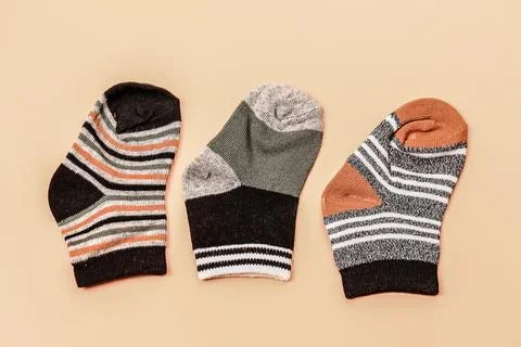 Different socks beige background with copy space. Flat lay. Top view. Stock Photos