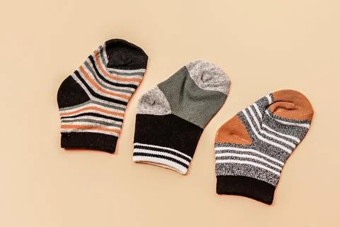 Different socks beige background with copy space. Flat lay. Top view. Stock Photos