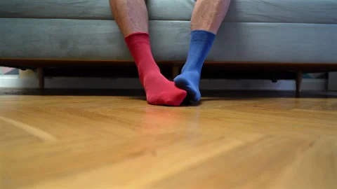 Different socks in legs. Mismatched multicolored socks on feet man. Stock Footage 308489578