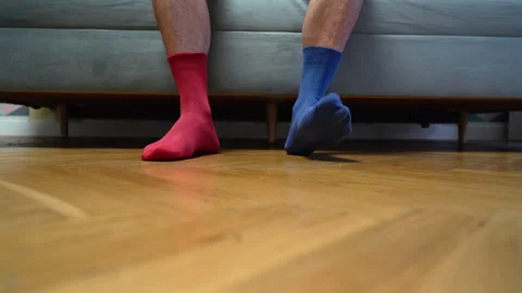 Different socks in legs. Mismatched multicolored socks on feet man Video stock 308515474