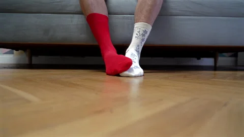 Different socks in legs. Mismatched multicolored socks on feet man Video stock 308516533