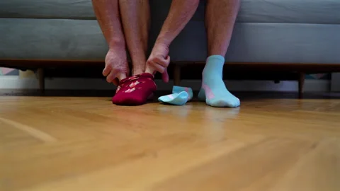 Different socks in legs. Mismatched multicolored socks on feet man Video stock 308531573