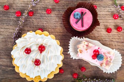Different sort of beautiful pastry, small colorful sweet cakes Stock Photos