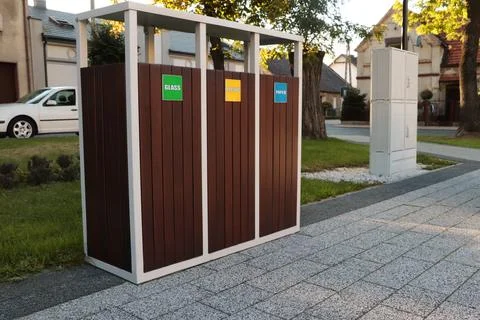 Different sorting bins for waste recycling on city street outdoors Stock Photos