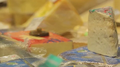 Different sorts of cheese on the counter in the grocery store Stock Footage 75346760