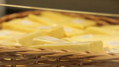 Different sorts of cheese on the counter in the grocery store, close-up Stock Footage 75346820