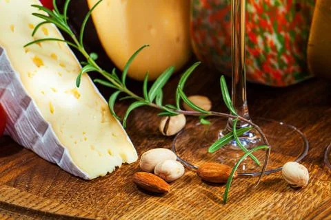 Different sorts of cheese on kitchen table. Stock Photos