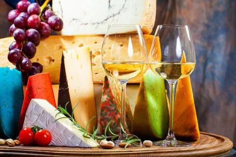 Different sorts of cheese on kitchen table Stock Photos