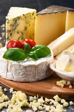 Different sorts of cheese on kitchen table. Stock Photos
