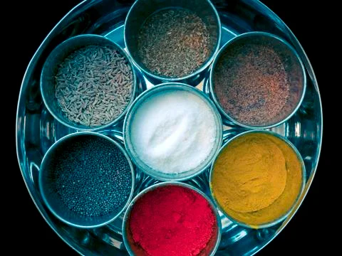 Different spices kept in different tins Stock Photos