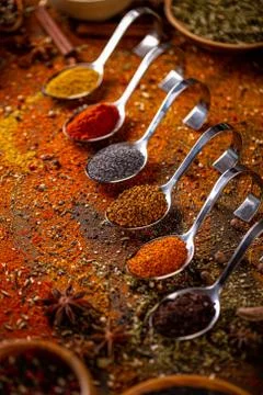 Different spices in spoons Stock Photos