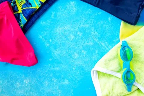 Different stylish beach accessories on a blue background, top view. Stock Photos