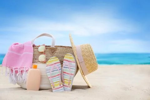 Different stylish beach objects on sand near sea Stock Photos