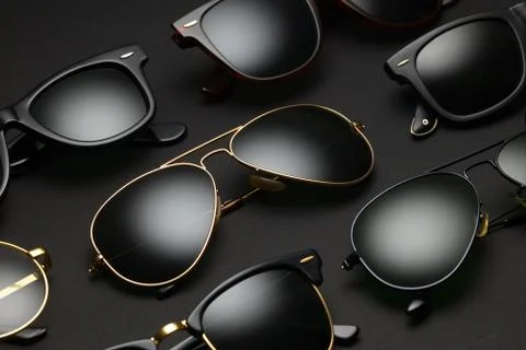 Different sunglasses on black background Stock Photos
