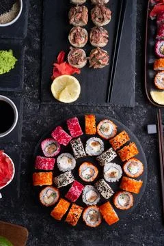 Different sushi rolls set  with fish and  shiitake mushrooms  served  at blac Stock Photos