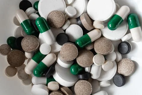 Different tablets and pills at white background Stock Photos