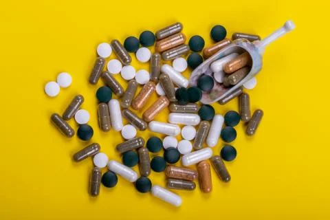 Different tablets on the yellow background Stock Photos