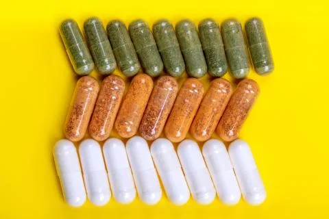 Different tablets on the yellow background Stock Photos