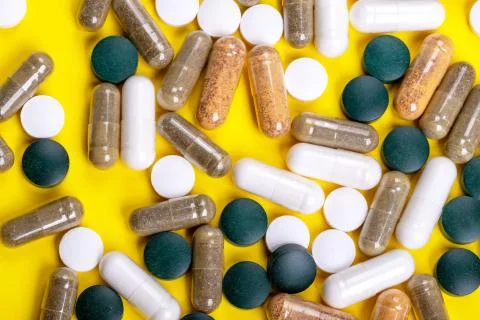 Different tablets on the yellow background Stock Photos