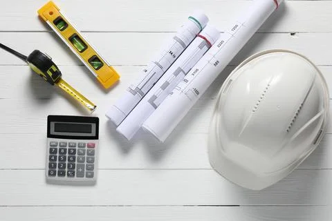 Different technical drawings, hard hat, calculator, building level and meas.. Fotos de archivo