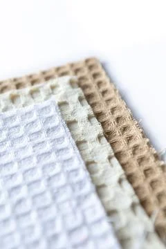 Different textured fabrics stacked on top of each other showing patterns an.. Stock Photos