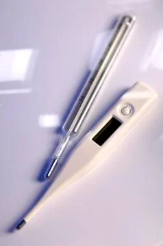 Different thermometers on gray background Stock Photos