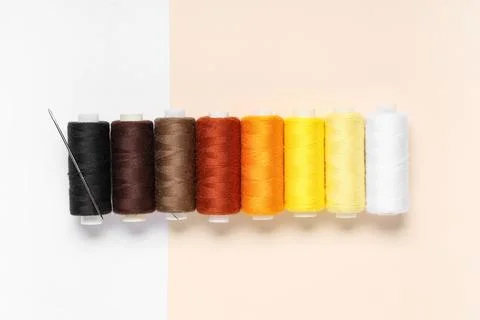 Different thread spools on color background 写真素材