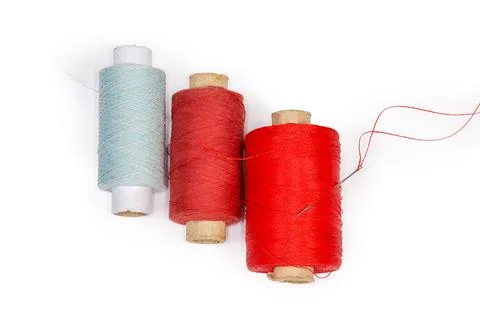 Different threads spools, hand sewing needle with thread, top view Stock Photos