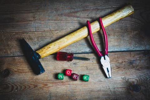 Different tools and the letters work on a wooden surface Stock Photos