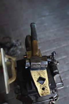 Different tools of blacksmith in workshop in forge Stock Photos