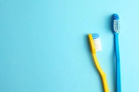 Different toothbrushes on a colored background. Dental care, oral health. Stock Photos