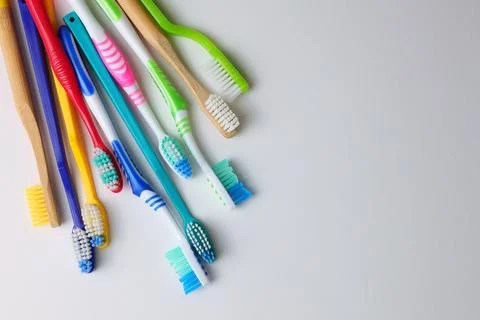Different toothbrushes on a colored background. Dental care, oral health. Stock Photos