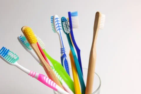 Different toothbrushes on a colored background. Dental care, oral health. Stock Photos
