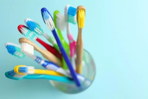 Different toothbrushes on a colored background. Dental care, oral health. Stock Photos