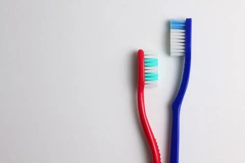 Different toothbrushes on a colored background. Dental care, oral health. Stock Photos