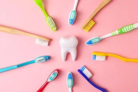 Different toothbrushes on a colored background. Dental care, oral health. Stock Photos