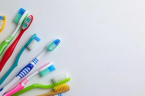 Different toothbrushes on a colored background. Dental care, oral health. Stock Photos