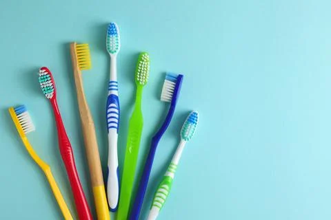 Different toothbrushes on a colored background. Dental care, oral health. Stock Photos