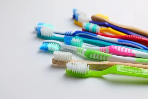 Different toothbrushes on a colored background. Dental care, oral health. Stock Photos