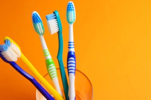 Different toothbrushes on a colored background. Dental care, oral health. Foto stock