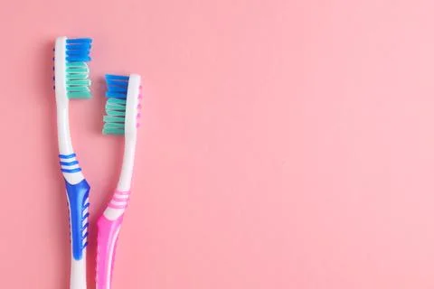 Different toothbrushes on a colored background. Dental care, oral health. Stock Photos