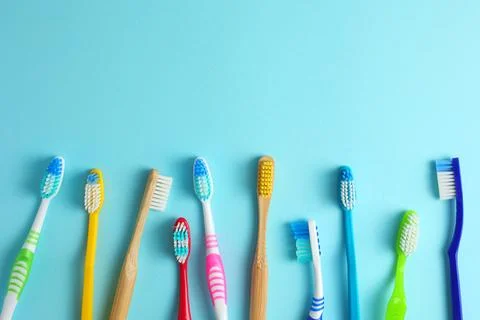 Different toothbrushes on a colored background. Dental care, oral health. Stock Photos