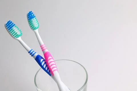 Different toothbrushes on a colored background. Dental care, oral health. Stock Photos