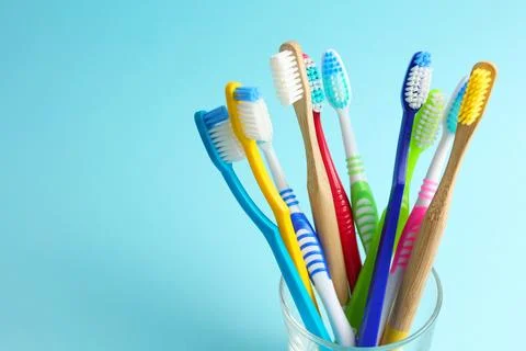 Different toothbrushes on a colored background. Dental care, oral health. Stock Photos