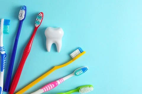 Different toothbrushes on a colored background. Dental care, oral health. Stock Photos