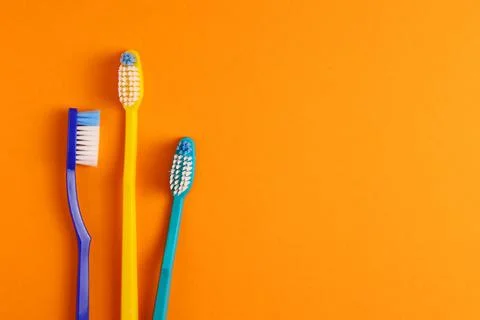 Different toothbrushes on a colored background. Dental care, oral health. Stock Photos