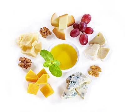 Different type of cheese with honey, grape, nuts on white background. Top view Stock Photos